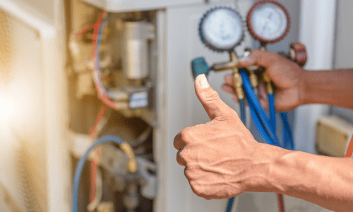 Certified HVAC technician professionally installing a modern HVAC system in a bright home.Close-up of a technician giving a thumbs-up while inspecting HVAC system pressure gauges.